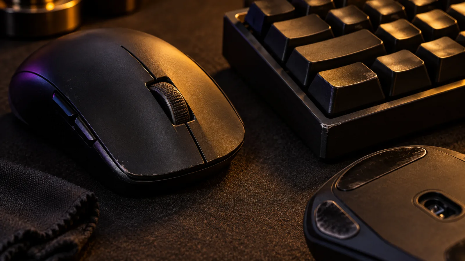 Close inspection of minor wear on a matte-black gaming mouse and keyboard
